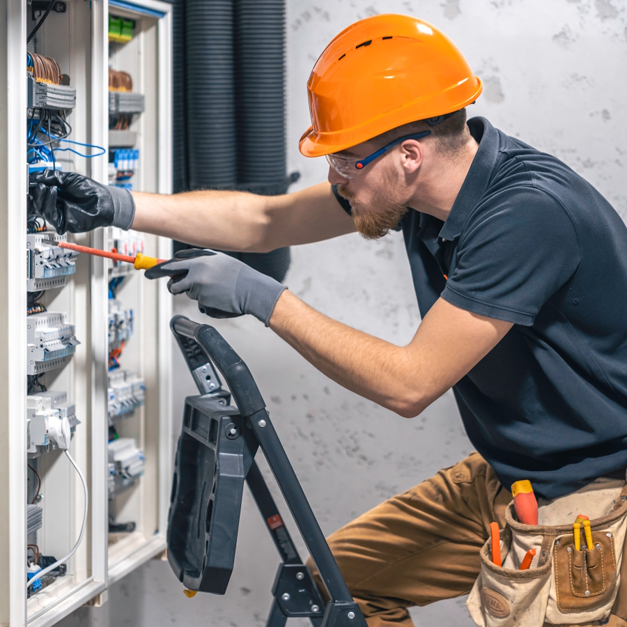 Professional electrician working on electrical panel